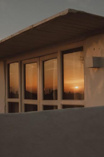 a window of a house with a sunset in it at Dreamsea Imsouane Morocco in Imsouane