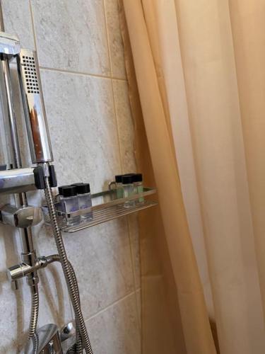 a shower with a glass shelf in a bathroom at Cozy studio apartment 2 in Kallithea Rhodes