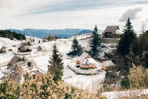 a snow covered village on a snow covered mountain at Chalet Lepenatka with Sauna - I feel Alps in Stahovica