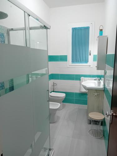 a bathroom with a toilet and a sink at MareFuori in Giardini Naxos