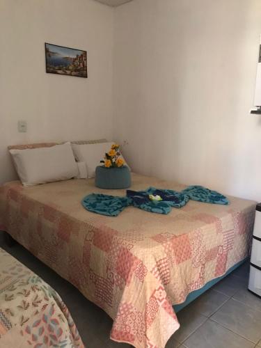 a bedroom with a bed with a blanket on it at Cantinho da mery in Maragogi