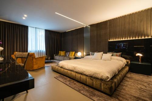 a bedroom with a large bed and a couch at Hotel Ariston in Paestum
