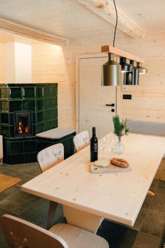 a dining room with a table and a fireplace at Chalet Lepenatka with Sauna - I feel Alps in Stahovica