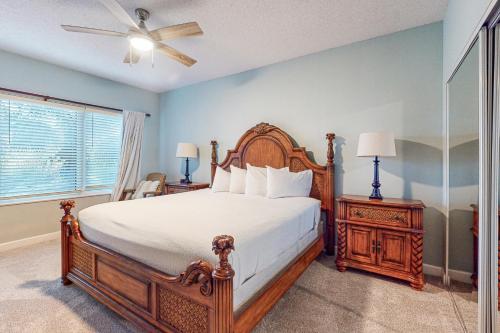 a bedroom with a large bed and a ceiling fan at TOPS'L Summit 210 in Destin
