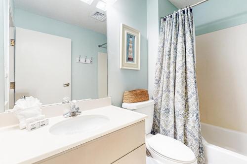 a bathroom with a sink and a toilet at TOPS'L Summit 210 in Destin