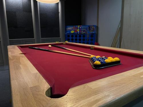 a pool table with a tray of balls on it at PartyPad Newcastle in Saint Peters
