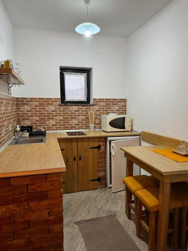 a kitchen with a table and a counter top at Constantin Panzió in Praid
