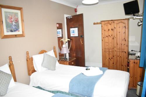 Katil atau katil-katil dalam bilik di Pickwicks Guest House