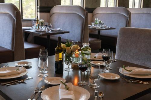 a table in a restaurant with plates and wine glasses at Firefall Ranch Yosemite in Groveland