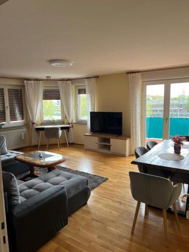 a living room with a couch and a table at Albert-Schulte-Park Apartment- Worms in Worms