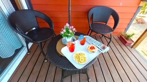 a table with a tray of food on a deck at Chan Beach Resort & Hotel in Bahūr