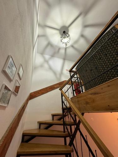 a spiral staircase with a ceiling fan in a house at Constantin Panzió in Praid
