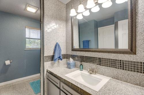 a bathroom with a sink and a mirror at Family-Friendly San Antonio Getaway with Fire Pit! in San Antonio