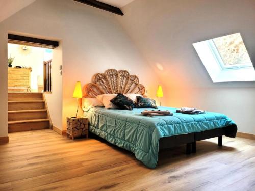 a bedroom with a bed with a headboard and stairs at Gîte de France Gîte le petit air 3 épis - Gîte de France 3 personnes MAE-6624 in Argentat