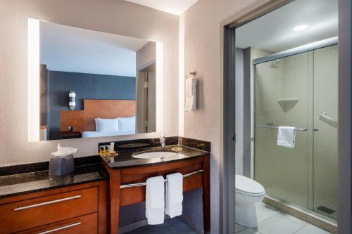 a bathroom with a sink and a toilet and a shower at Hyatt Place Santa Fe in Santa Fe