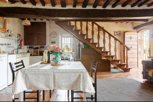 a kitchen with a table with a vase of flowers on it at Appartamento Iesa in Lama