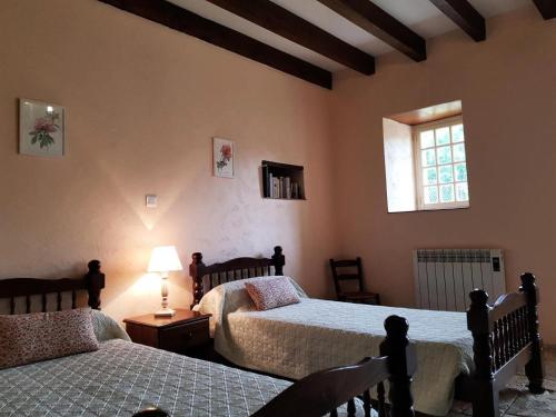 een slaapkamer met 2 bedden en een raam bij Gîte de France Combelonge 3 épis - Gîte de France 6 personnes 874 in Turenne
