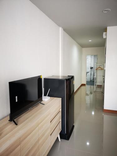 a living room with a large flat screen tv at Proud Room &wifi 2 in North Pattaya