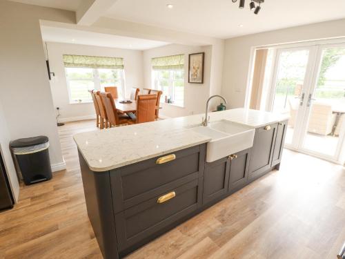 a kitchen with a sink and a counter top at Foremans Cottage in Hull