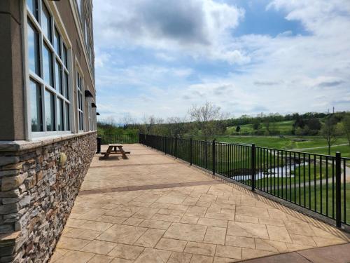 a balcony of a building with a bench on it at Doubletree By Hilton Front Royal Blue Ridge Shadows in Front Royal