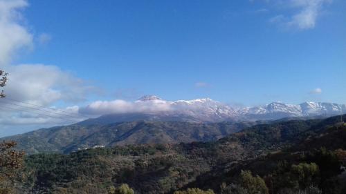 a view of a mountain with snow capped mountains at Zorbas Apartments in Volissos