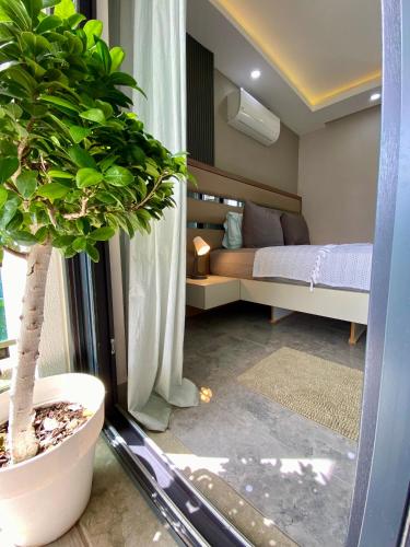 a bedroom with a bed and a potted plant at Villa Annabèll1 with Swimming pool and Jacuzzi, 3 floors in Belek