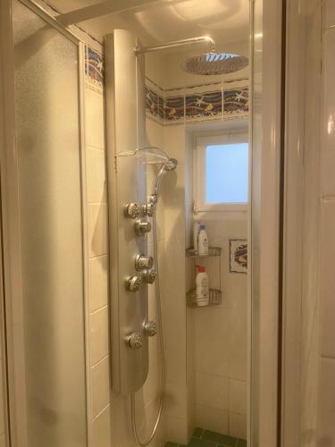 a shower with a glass door in a bathroom at Maison à 10 m de la mer hyper centre in Les Sables-d'Olonne