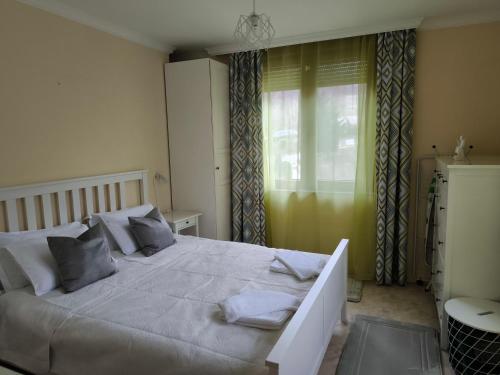 a bedroom with a large white bed with gray pillows at Sea Bliss Retreat -Santa Marina - Sozopol in Sozopol
