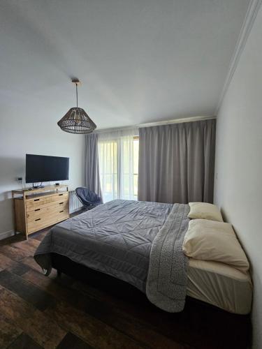 um quarto com uma cama e uma televisão de ecrã plano em Monoambiente a estrenar en Bariloche em San Carlos de Bariloche