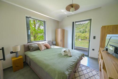 a bedroom with a bed with a dog laying on it at Antinea Olympian Villa in Olympia
