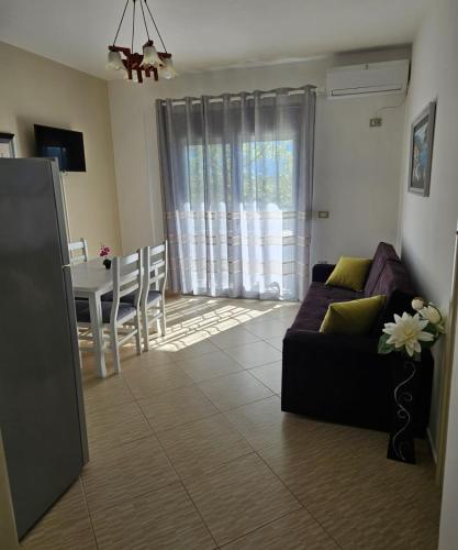 a living room with a couch and a table at Vacanze Pushime Albania in Radhimë