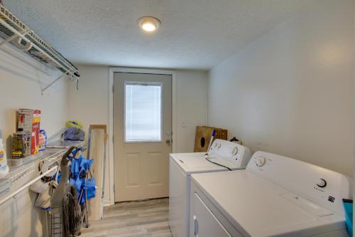 a laundry room with white appliances and a door at Albany Family Lake Getaway Near State Parks! in Albany