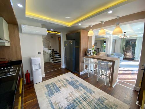 a kitchen with a refrigerator and a table in it at Villa Annabèll1 with Swimming pool and Jacuzzi, 3 floors in Belek