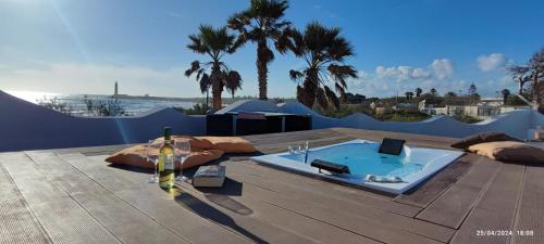 a hot tub sitting on top of a wooden deck at Villa Oasi dune e mare in Campobello di Mazara