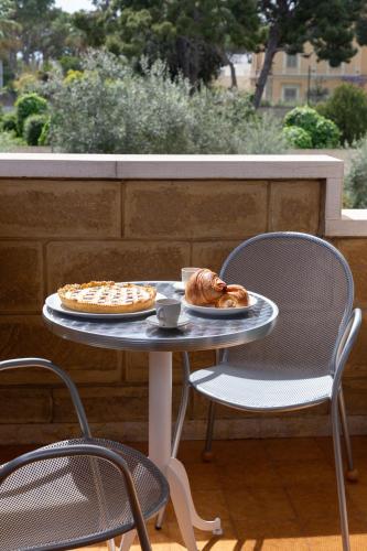 a table with a plate of food and a pie at B&B Le foglie d'ulivo in Bari
