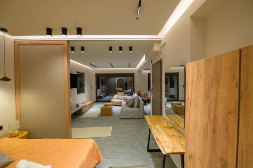 a room with a bed and a living room at Antinea Olympian Villa in Olympia