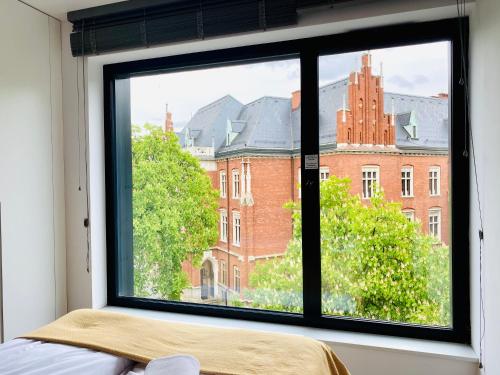 a bedroom window with a view of a building at PANORAMA VIEW by Mint Apartment in Krakow