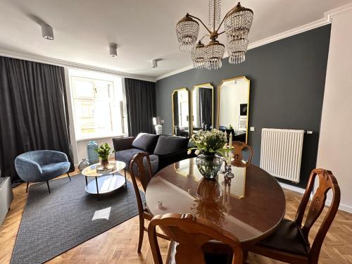 a living room with a table and a couch at Main Square Apartments Sylvi in Krakow