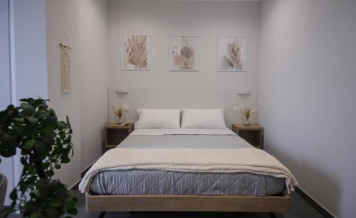 1 cama en un dormitorio con 3 cuadros en la pared en Terra Mia Fonseca B&B en Nápoles