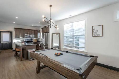 a living room with a pool table in it at Downtown Chattanooga that Sleeps 8 with a Pool Table in Chattanooga