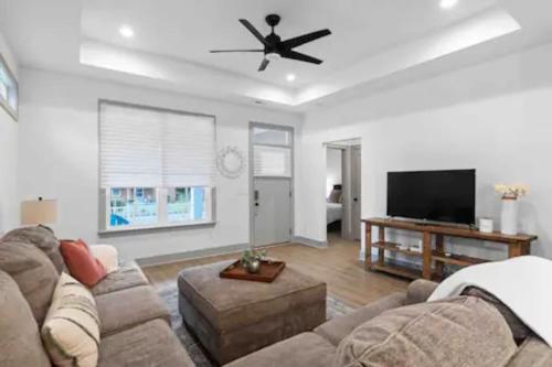 a living room with a couch and a flat screen tv at Discover Charm Cozy in the Heart of the City in Chattanooga