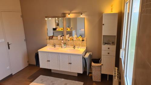 a bathroom with a sink and a mirror at Casa DAMG in Loucelles