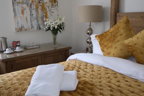 a bedroom with two beds and a vase of flowers at The Barrington Guesthouse Hotel in Scarborough