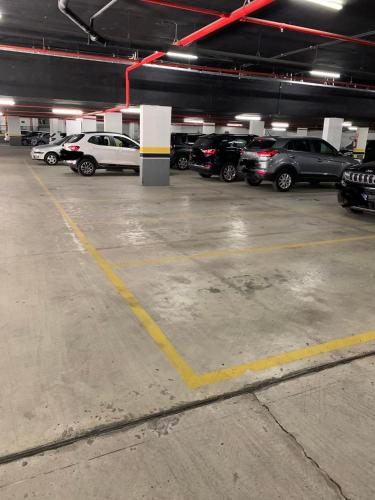 a parking lot full of cars in a parking garage at Apartamento Hotel Itaipava Petropolis in Petrópolis