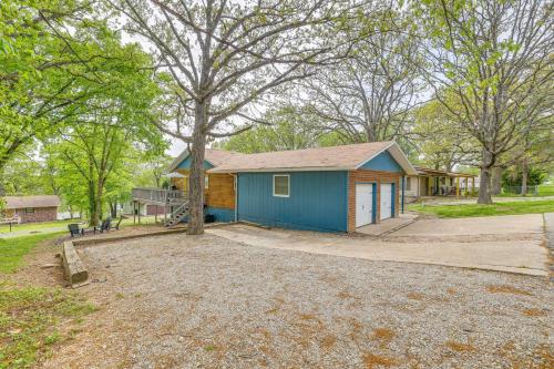 a small house with a blue garage in a yard at Deck and Table Rock Lake View Shell Knob Escape! in Shell Knob
