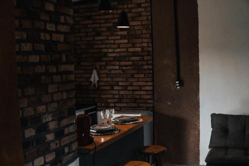 una sala da pranzo con tavolo e muro di mattoni di Bangalô Alto da Pedreira a Socorro