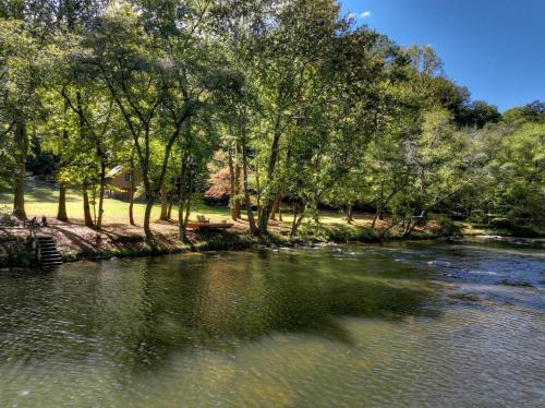a river with trees on the side of it at Crescent Moon on the River in Ellijay