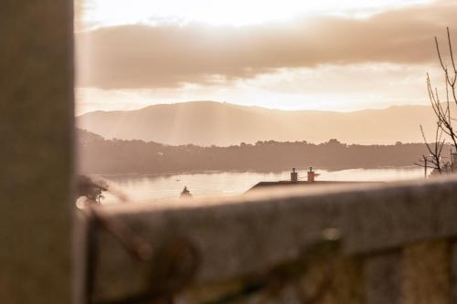 a view of a body of water with mountains in the background at Apartamentos Rurales de Abelleira in Muros