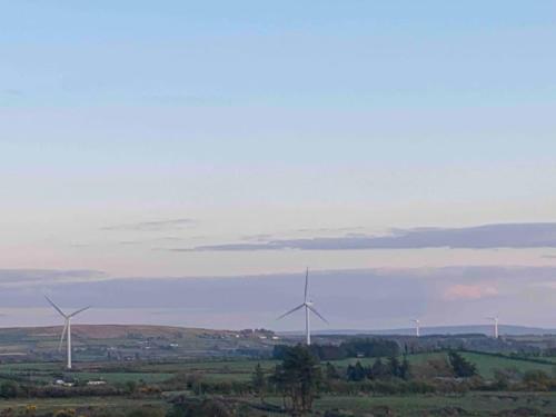 a group of wind turbines in a field at Hannahs Cottage 