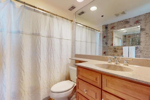 a bathroom with a sink and a toilet and a shower curtain at Sea Colony - Georgetowne House 409 in Bethany Beach